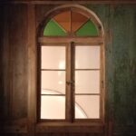 Okno z witrażem w górnej części w kuczce
